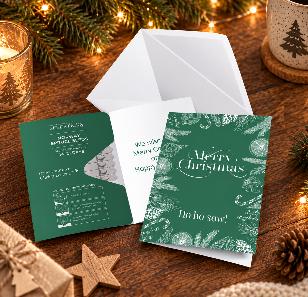 Merry Christmas Greeting Card Seedsticks with green card, envelope and planting gift in a festive setting